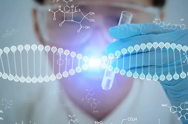 Scientist holding test tube with DNA model