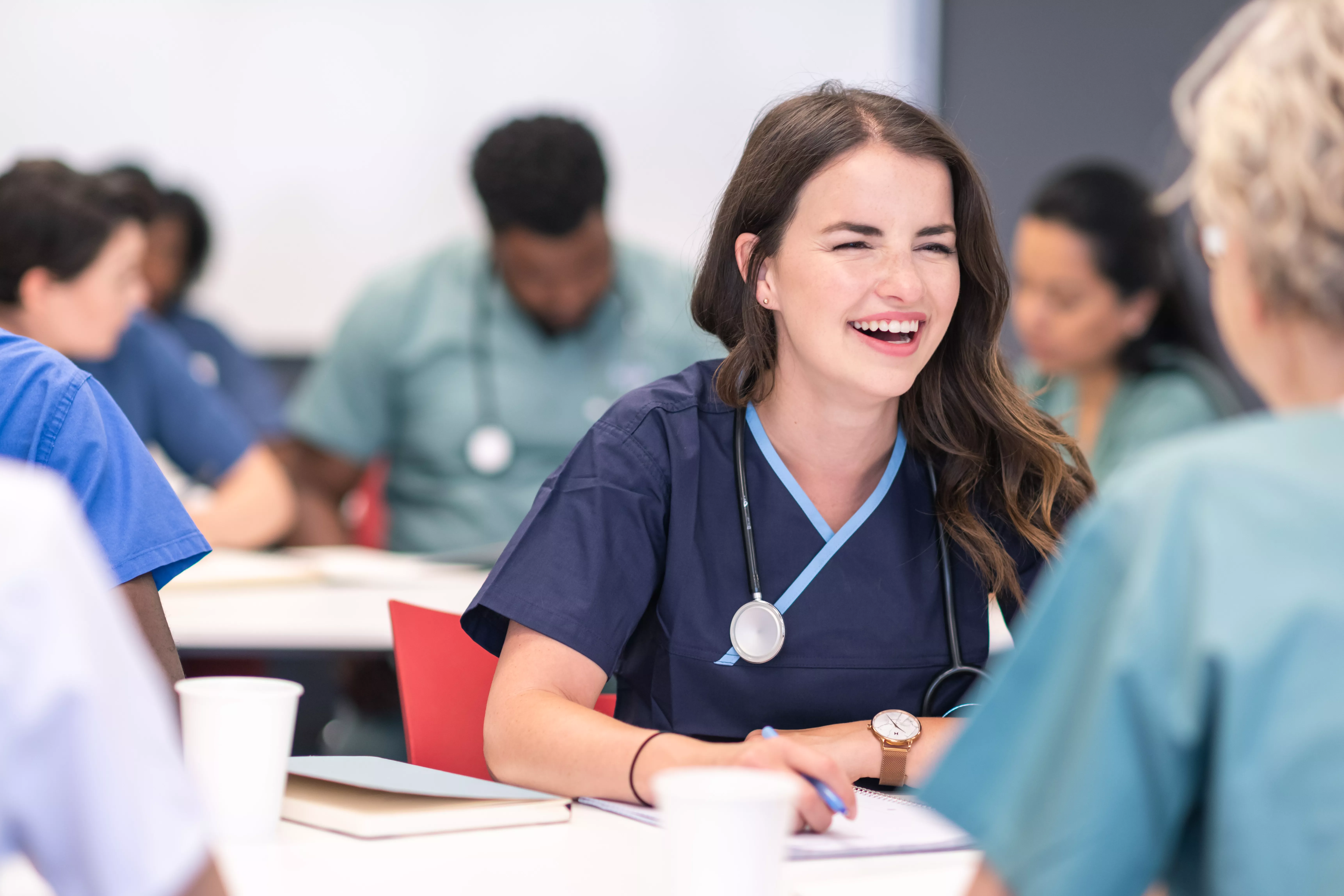 Laughing nursing student with other students