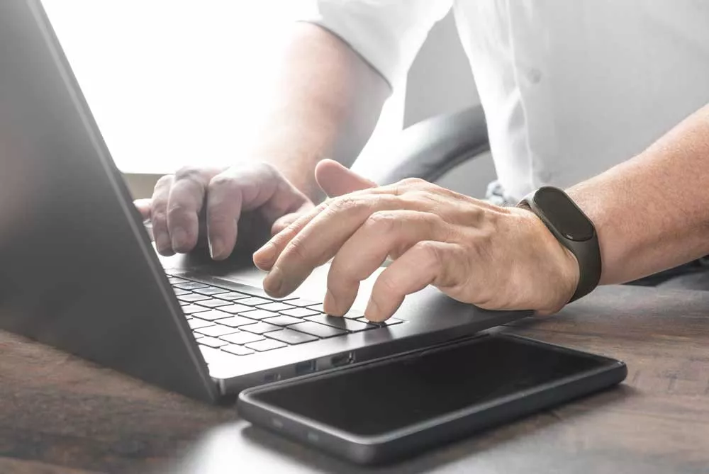 Man typing on laptop