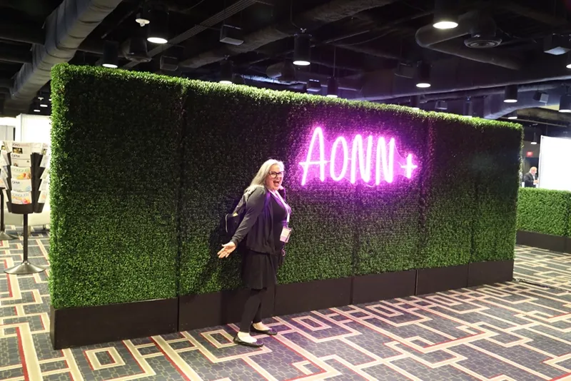 In front of the glowing AONN+ sign